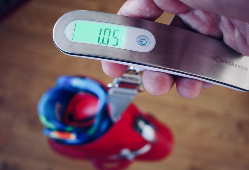 Wakeboard binding being weighted on a handheld scale