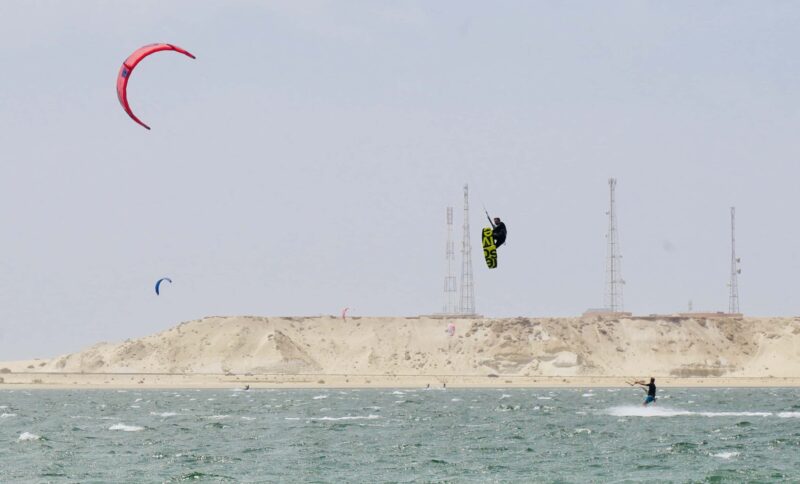 Kitelement Re Solve split kiteboard high in the air.