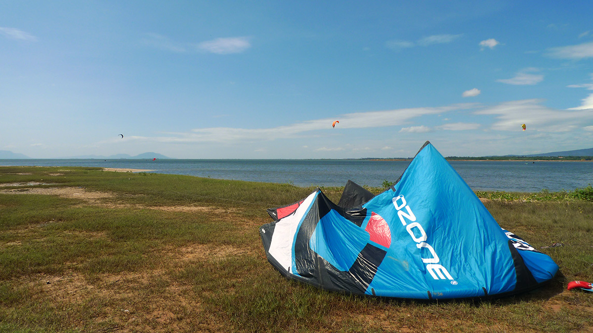 Kampot kitesurf spot with a kite on land and lessons in the water.