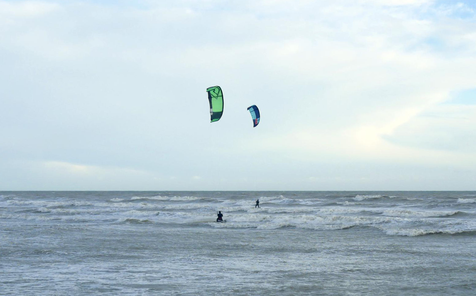 Two kitesurfers riding at King Alfred in Hove, UK.