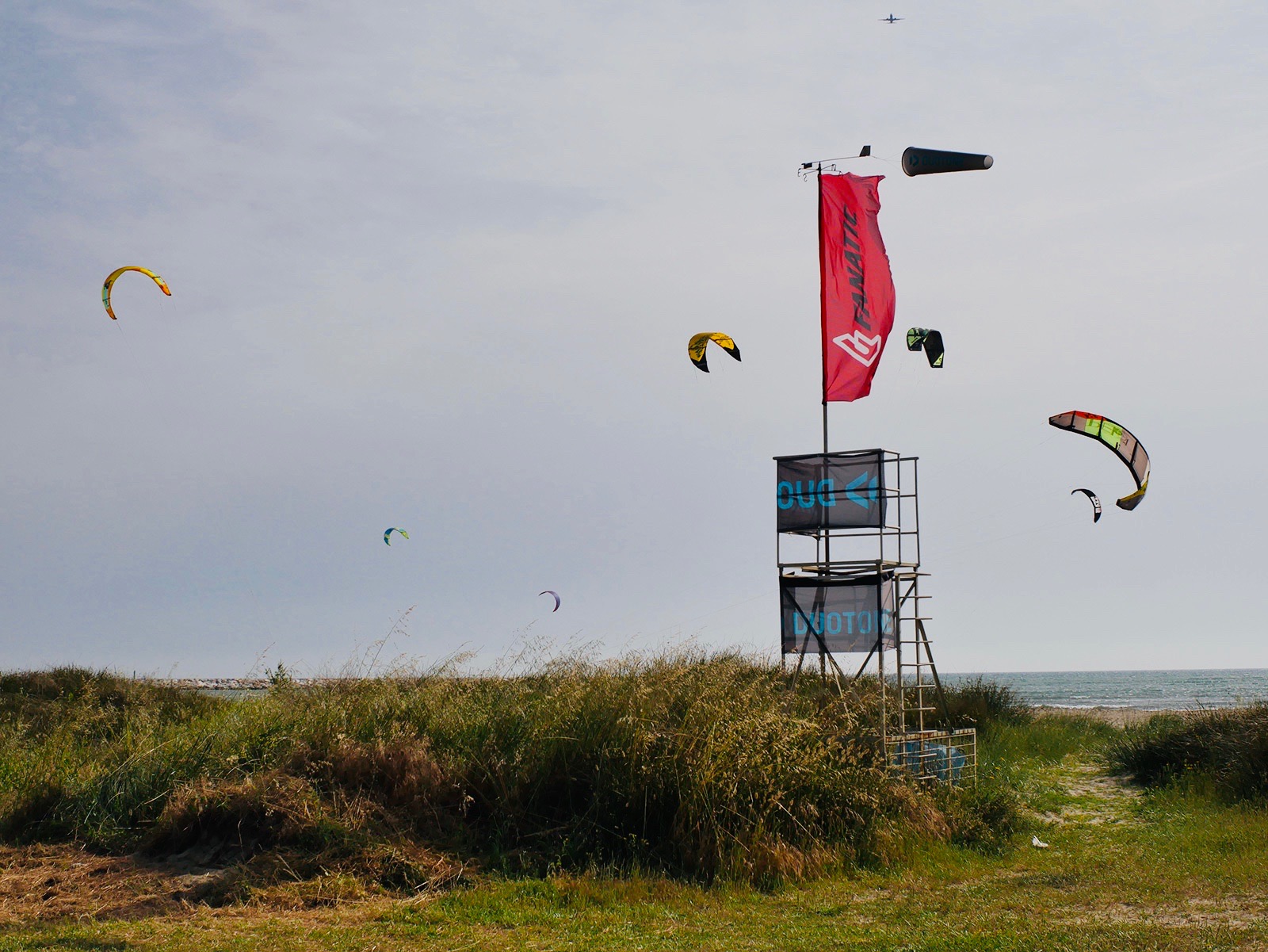 Wind sock and kites flying in the air at Calambrone kite centre.