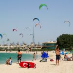 Kites flying at Nessnass beach in Dubai with Burj Khalifa in the background
