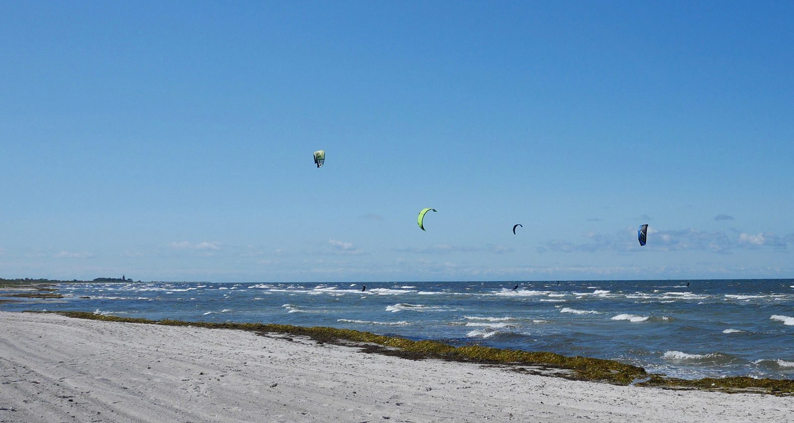 Skanor and kitesurfer on a sunny day.